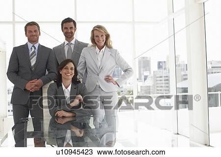 Stock Image - Boss with her team. Fotosearch