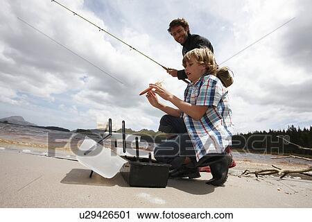 Boy and his father fishing View Large Photo Image Stock Image - Boy and his father fishing. Fotosearch