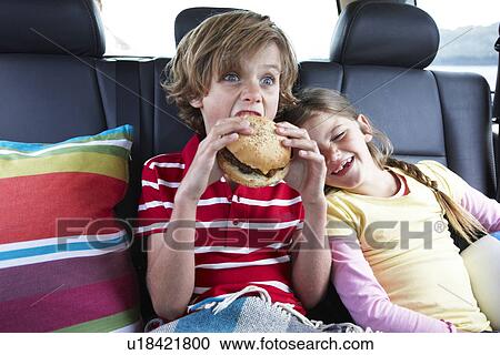 Boy eating a hamburger View Large Photo Image Stock Image - Boy eating a hamburger. Fotosearch