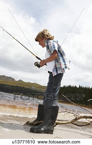Stock Image - Boy fishing. Fotosearch