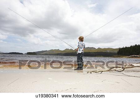 Stock Image - Boy fishing. Fotosearch