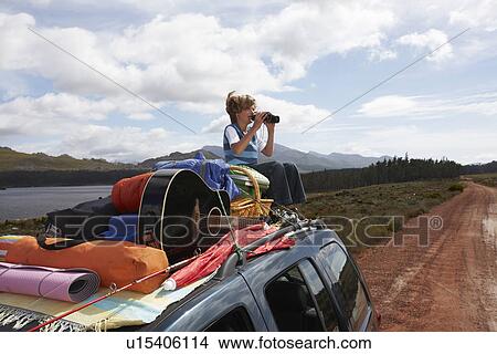 Boy sitting on a car View Large Photo Image Picture - Boy sitting on a car. Fotosearch
