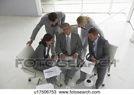 Stock Image - Business people at an office. Fotosearch