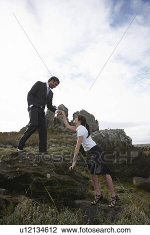 Business people on the rocks View Large Photo Image Stock Image - Business people on the rocks. Fotosearch