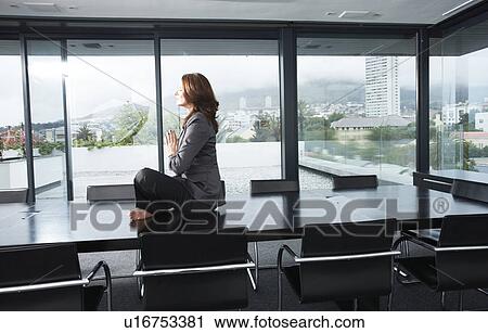 Business woman meditating View Large Photo Image Stock Image - Business woman meditating. Fotosearch