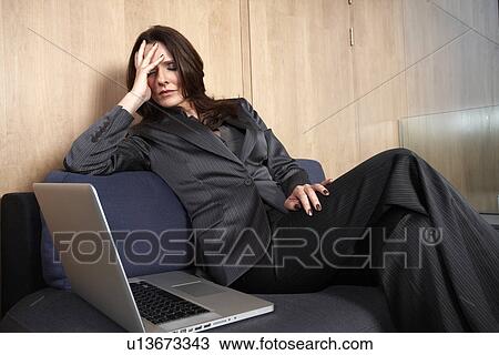 Business woman sleeping on a sofa View Large Photo Image Stock Image - Business woman sleeping on a sofa. Fotosearch