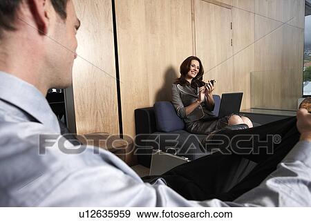 Stock Photo - Business woman waiting in a reception. Fotosearch