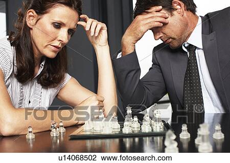 Businessman and businesswoman playing chess View Large Photo Image Stock Image - Businessman and businesswoman playing chess. Fotosearch