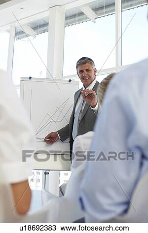 Businessman at a conference View Large Photo Image Stock Image - Businessman at a conference. Fotosearch