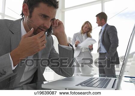 Businessman at an office View Large Photo Image Stock Photo - Businessman at an office. Fotosearch