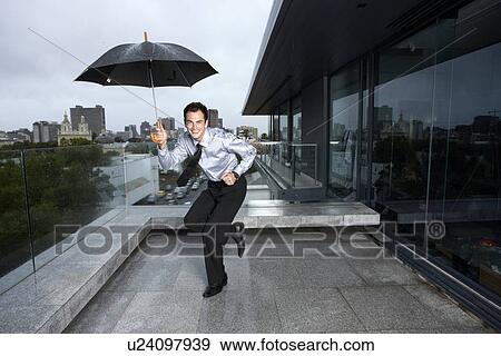 Stock Photo - Businessman dancing in the rain. Fotosearch