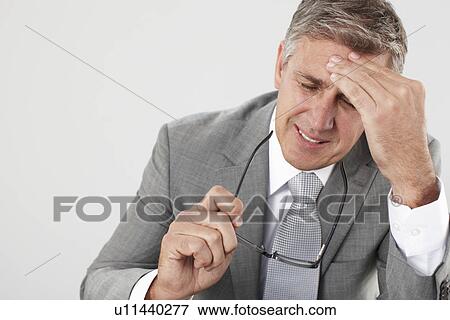 Stock Photo - Businessman having headache. Fotosearch