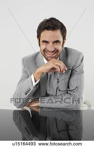 Businessman holding glasses View Large Photo Image Stock Image - Businessman holding glasses. Fotosearch