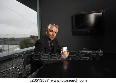Stock Photo - Businessman in a meeting room. Fotosearch