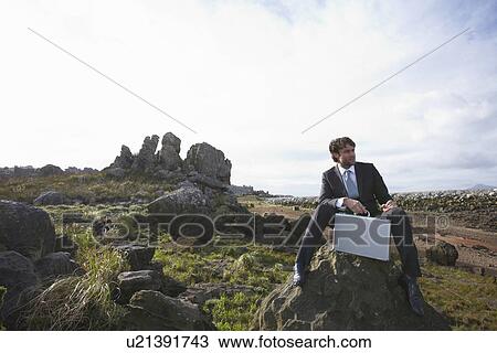 Stock Image - Businessman in the middle of nowhere. Fotosearch