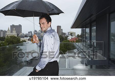 Businessman outdoors in the rain View Large Photo Image Picture - Businessman outdoors in the rain. Fotosearch