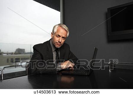Stock Image - Businessman with a computer. Fotosearch