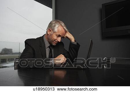 Stock Image - Businessman with a laptop. Fotosearch