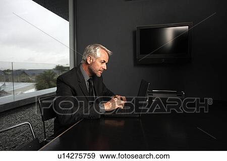 Businessman with a laptop View Large Photo Image Stock Photo - Businessman with a laptop. Fotosearch