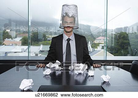 Businessman with a trash box on his head View Large Photo Image Stock Image - Businessman with a trash box on his head. Fotosearch