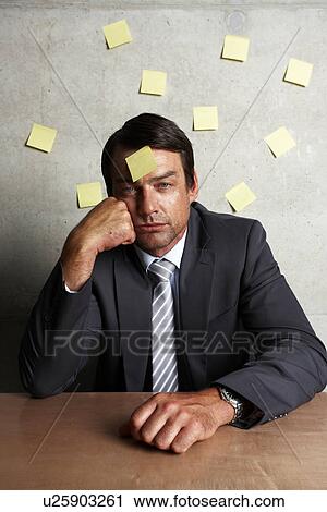 Stock Image - Businessman with sticky notes. Fotosearch