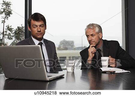Stock Photo - Businessmen at work. Fotosearch