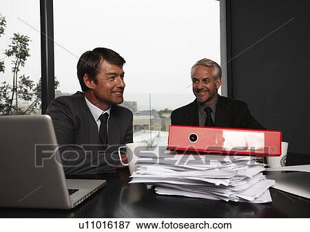 Stock Photo - Businessmen at work. Fotosearch