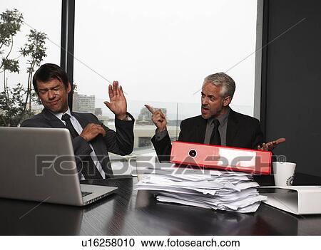 Stock Image - Businessmen fighting. Fotosearch