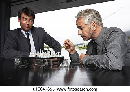 Stock Photography - Businessmen playing chess. Fotosearch