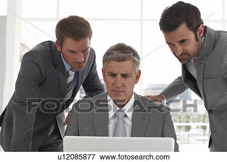 Businessmen with a computer View Large Photo Image Stock Photo - Businessmen with a computer. Fotosearch