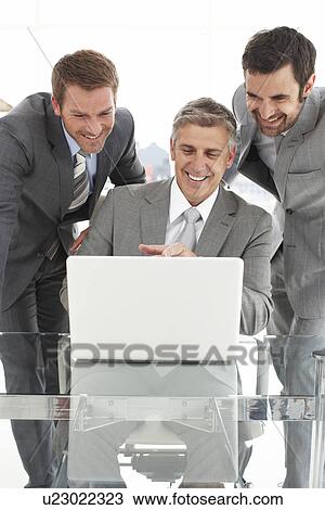 Stock Image - Businessmen with a laptop. Fotosearch
