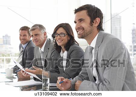 Stock Image - Businesspeople listening to a candidate. Fotosearch