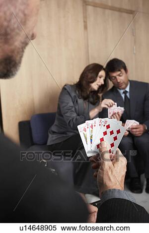 Stock Photography - Businesspeople playing with cards. Fotosearch