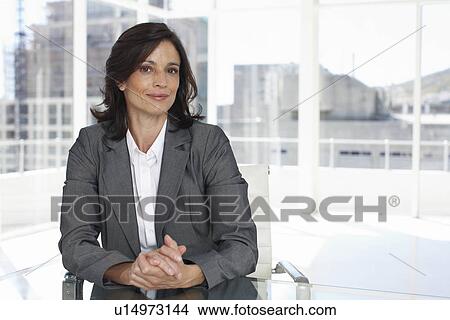 Picture - Businesswoman with construction in the background. Fotosearch