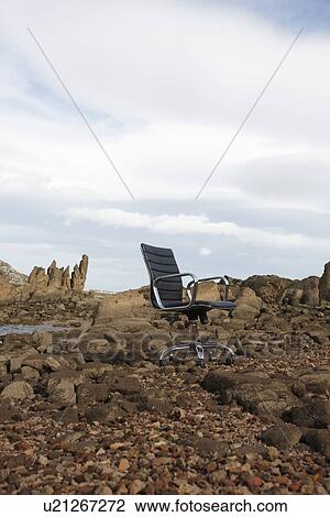 Stock Image - Chair on the rocks. Fotosearch