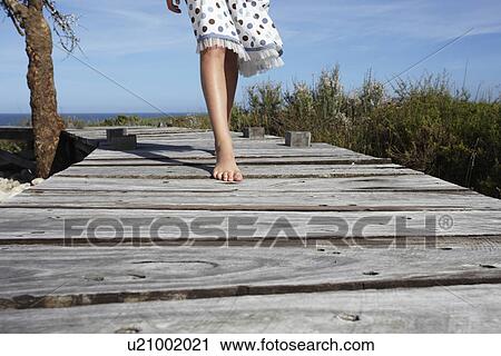 Stock Image - Child walking in the countryside. Fotosearch
