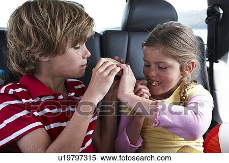 Stock Photography - Children sharing a hamburger. Fotosearch
