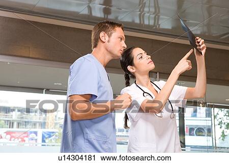 Colleagues examining x-ray View Large Photo Image Stock Image - Colleagues examining x-ray. Fotosearch