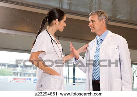 Colleagues having a conversation View Large Photo Image Stock Image - Colleagues having a conversation. Fotosearch