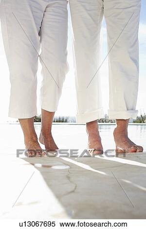 Couple close to a pool View Large Photo Image Stock Photography - Couple close to a pool. Fotosearch