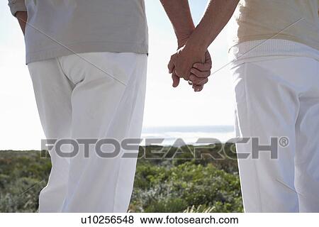 Couple holding hands View Large Photo Image Stock Photo - Couple holding hands. Fotosearch