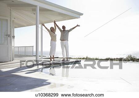 Stock Photo - Couple in their beach house. Fotosearch