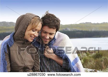 Couple listening to music View Large Photo Image Stock Image - Couple listening to music. Fotosearch