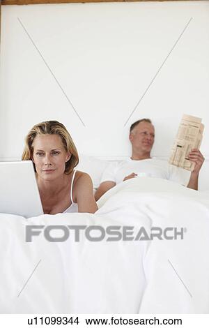 Picture - Couple spending time in bed. Fotosearch