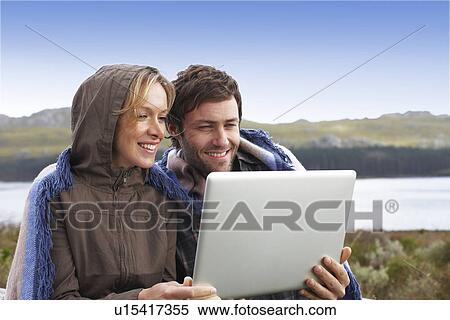 Couple with a computer View Large Photo Image Stock Photography - Couple with a computer. Fotosearch
