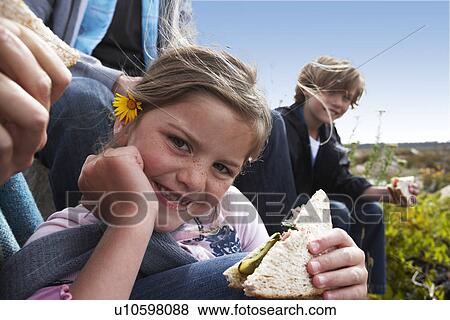 Stock Photo - Cute girl eating a sandwich. Fotosearch