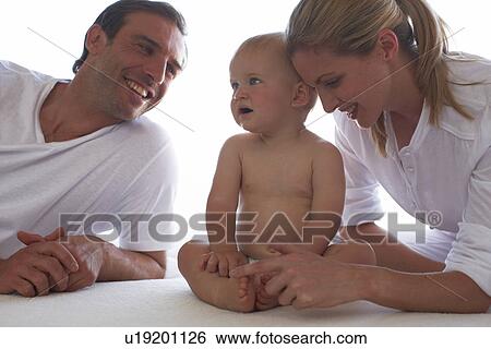 Stock Photograph - Cute young family. Fotosearch