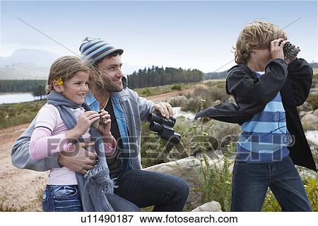Stock Photo - Dad with his kids. Fotosearch