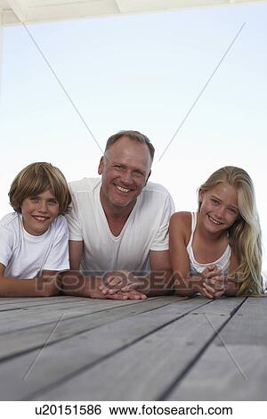 Stock Photograph - Dad with his kids. Fotosearch