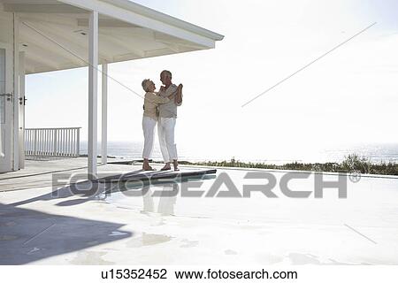 Stock Image - Dancing close to the pool. Fotosearch